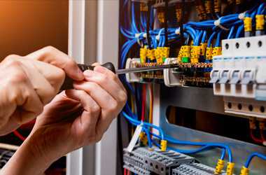 electrician installing whole-house surge protection to home's electrical panel