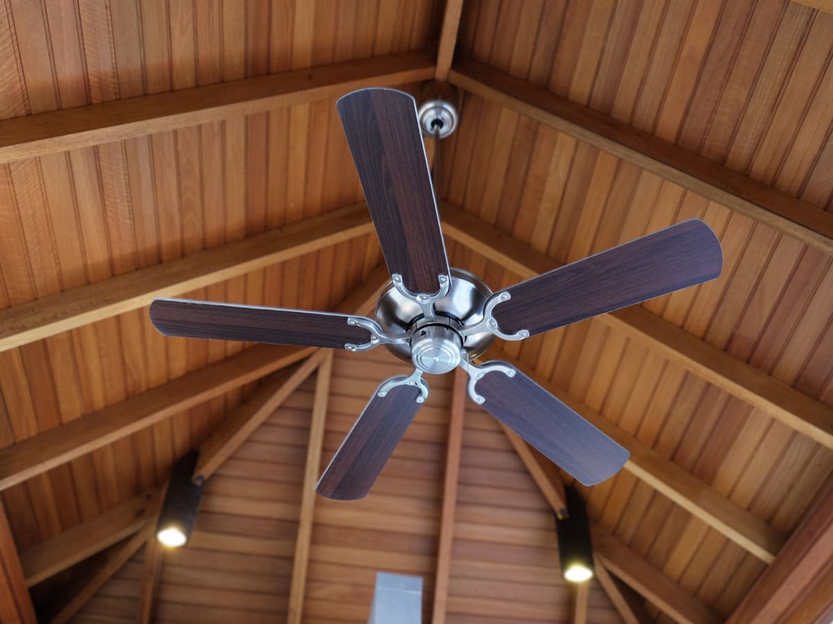 brown ceiling fan installed into wood ceiling