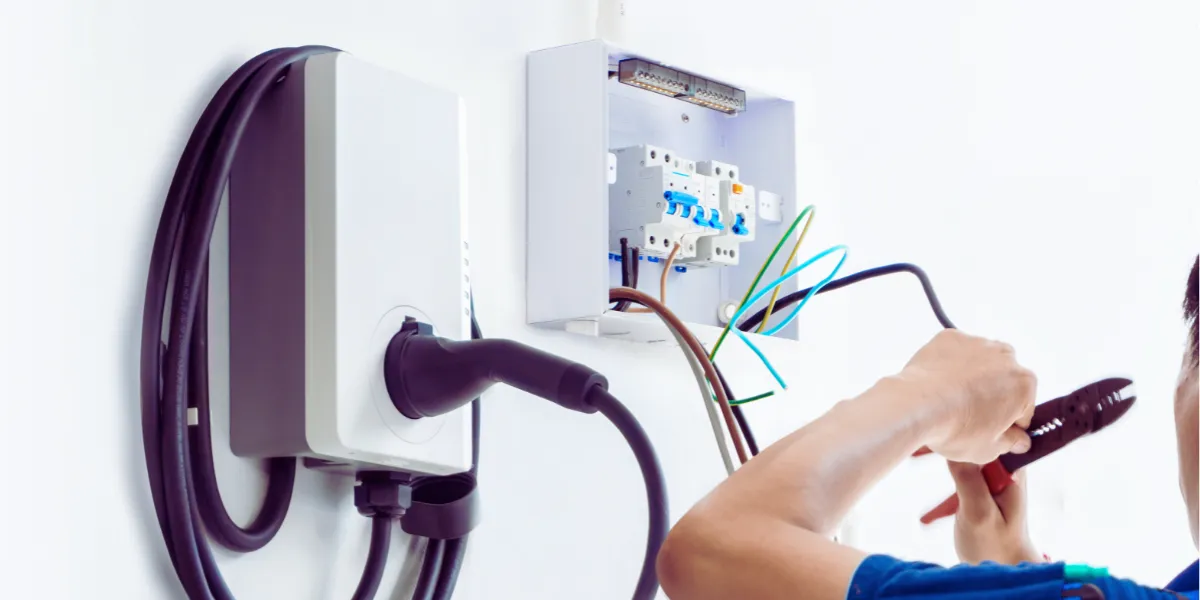 electrician installing ev charging station for homeowner