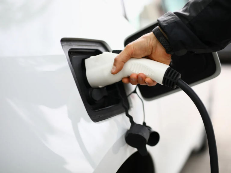 owner charging his electric car
