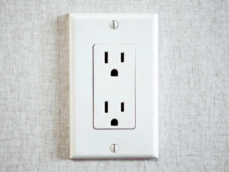 two prong outlet on grey wall