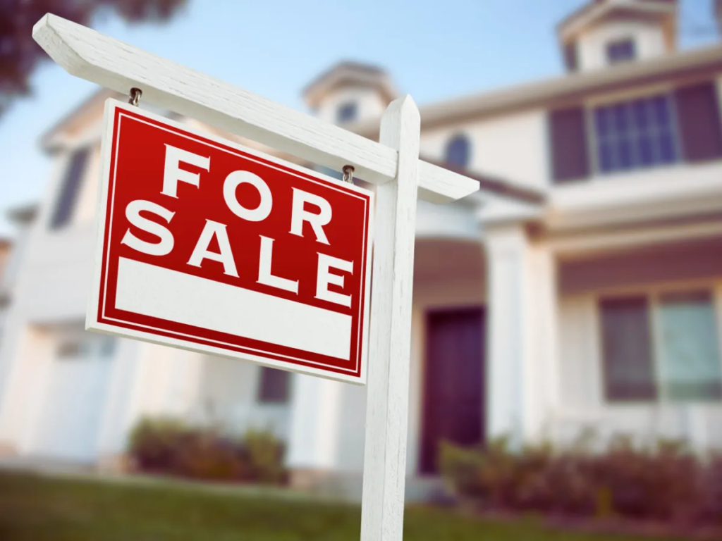 for sale sign outside suburban home