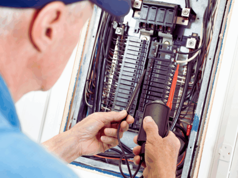 older electrician diagnosing breaker box issues