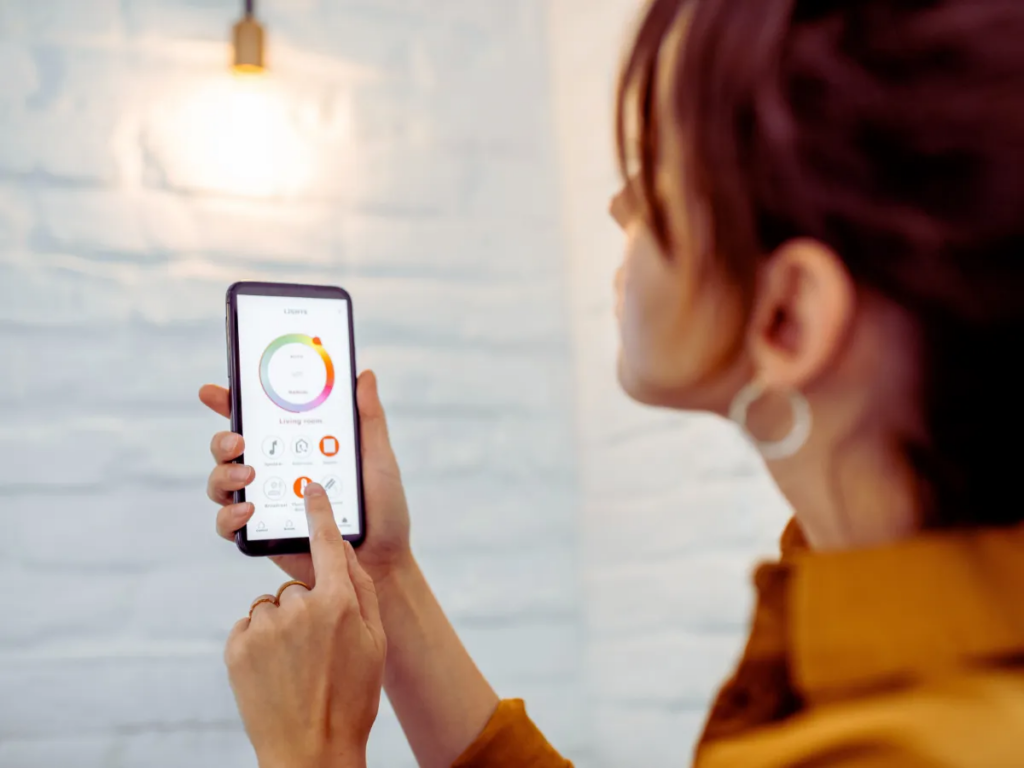 woman controlling living room smart light with her phone