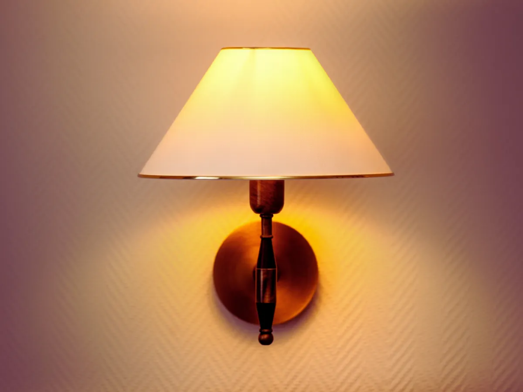 warm wall sconce lighting up dim room
